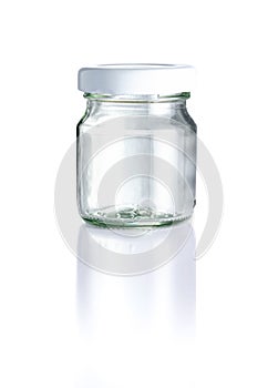 Empty clear glass jar, white cap in front view, and reflection isolated on white background, Suitable for Mock up creative graphic