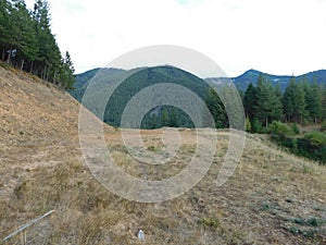 An empty clearing near Wilder, Idaho with a clear view of mountains all around,.