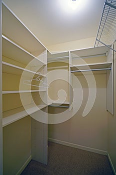 Empty clothes closet with shelves