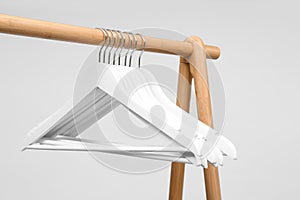 Empty clothes hangers on wooden rack