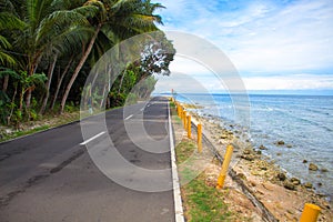 Empty coastal road by the sea. Tropical island holiday travel.