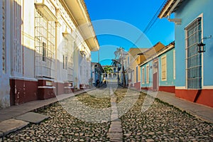 Empty cobblestone street with colonial colorful houses in Trinidad, Cuba. Beautiful Caribbean cityscape. UNESCO site famous