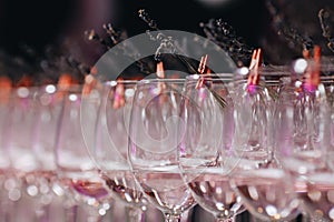 Empty cocktail glasses with a hint of lavender ready on edge