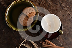 Empty cofee cup and cereal cookies on the old wooden table