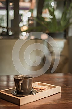 An empty coffee cup with cookie