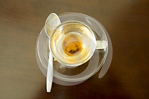 Empty coffee cup and teaspoon after drink coffee on wood table