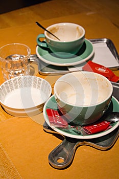 Empty coffee cups and bowl on a table