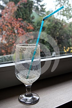Empty coffee glass with a straw. Empty ice coffee glass.