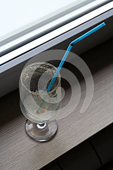 Empty coffee glass with a straw. Empty ice coffee glass.