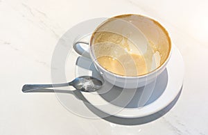 Empty coffee in mug and white Marble table after drink.