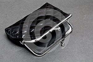 Empty coin purse on a dark background. Poverty. Hunger concept