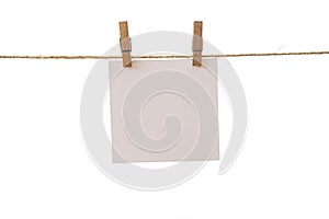 Empty color paper sheets for notes, frames that hang on a rope with clothespins and isolated on white