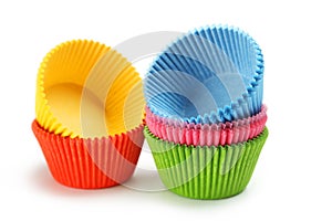 Empty colorful cupcake cases isolated on white background