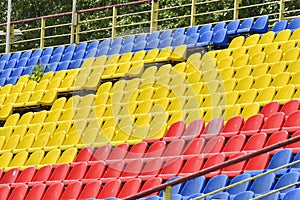Empty colorful seats in the stands of the stadium. The concept of the end, the beginning of the match, the competition. The end of