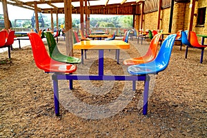 Empty coloured plastic tables and chairs