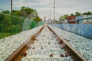 Empty rail tracks leading to a plant