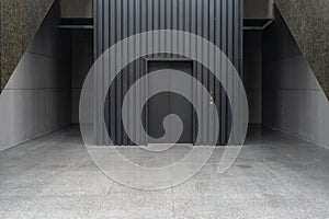 empty concrete floor in front of modern building entrance with elevator.