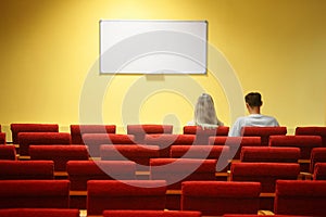 Empty conference hall. couple sitting in chairs