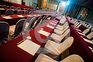 Empty conference hall with red table