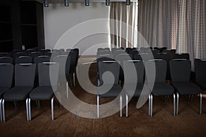 An empty conference room. Many chairs are arranged in rows. The concept of the financial crisis. Copy of the space