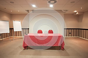 Empty conference room with red table