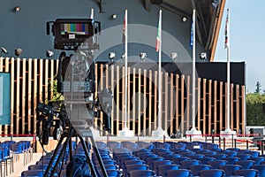 Empty Conference Room with Television Camera Ready for Audience