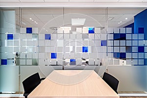 Empty conversation room with table and chairs in modern office interior.