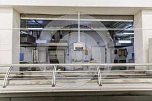 Empty cooking department at supermarket. Appliances, ovens and cutting tables with counters. Blurred