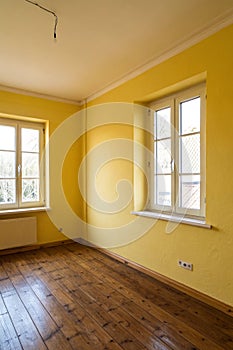 Empty corner yellow room with light from window