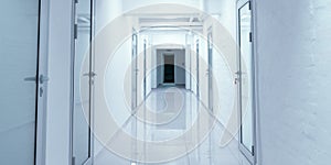 Empty corridor in hospital with closed doors