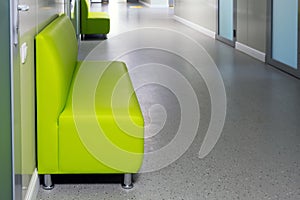 Empty corridor of a modern medical clinic with comfortable sofas