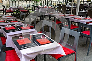 Empty cosy french street cafe or brasserie located on small river with served tables ready for visitors photo