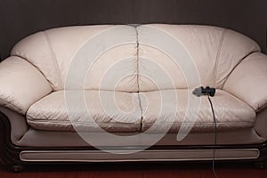 Empty couch with game controller