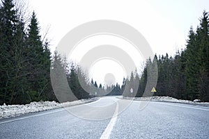 Empty country road in winter, roadside in the snow. Road trip concept. Winter trip