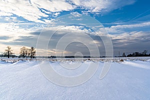 Empty Countryside Landscape in Sunny Winter Day with Snow Covering the Ground, Abstract Background with Deep Look and Dramatic