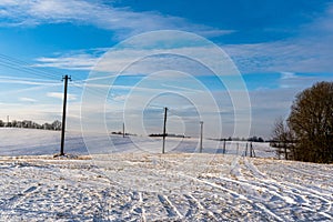 Empty Countryside Landscape in Sunny Winter Day with Snow Covering the Ground with Power Lines in Frame, Abstract Background