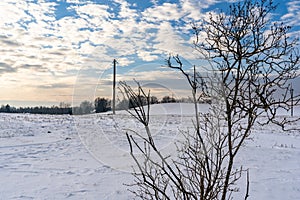 Empty Countryside Landscape in Sunny Winter Day with Snow Covering the Ground with Power Lines in Frame, Abstract Background with