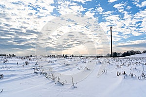 Empty Countryside Landscape in Sunny Winter Day with Snow Covering the Ground with Power Lines in Frame, Abstract Background with