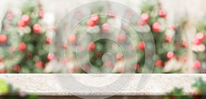 Empty cream marble table top with abstract blur christmas tree r