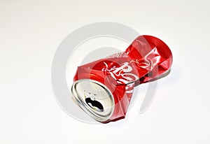 Empty crumpled can from a sweet carbonated drink. Aluminum can trash for disposal and recycling. Ð¡rushed soda cans