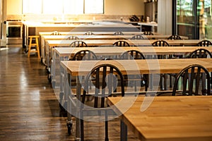 Empty culinary school classroom with rows of tables and chairs