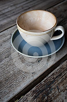 Empty cup of coffee in earthern ware cup with saucer