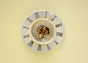 Empty cup of coffee on small plate on yellow background