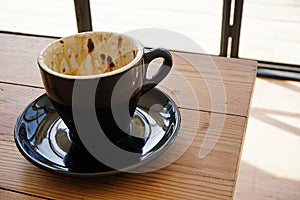 Empty cup of coffee on wooden table