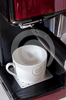 Empty cup in espresso machine.