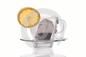 Cup with lemon slice and tea bag isolated on white background