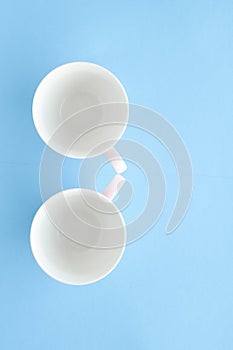 Empty cup and saucer on blue background, flatlay