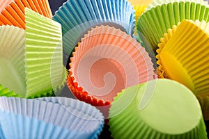 Empty cupcake cases, forms on blue background, table