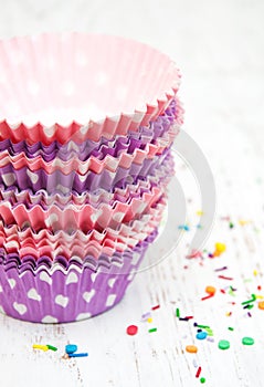 Empty cupcake cups and color sprinkles