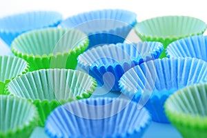Empty cupcake cups in green and blue